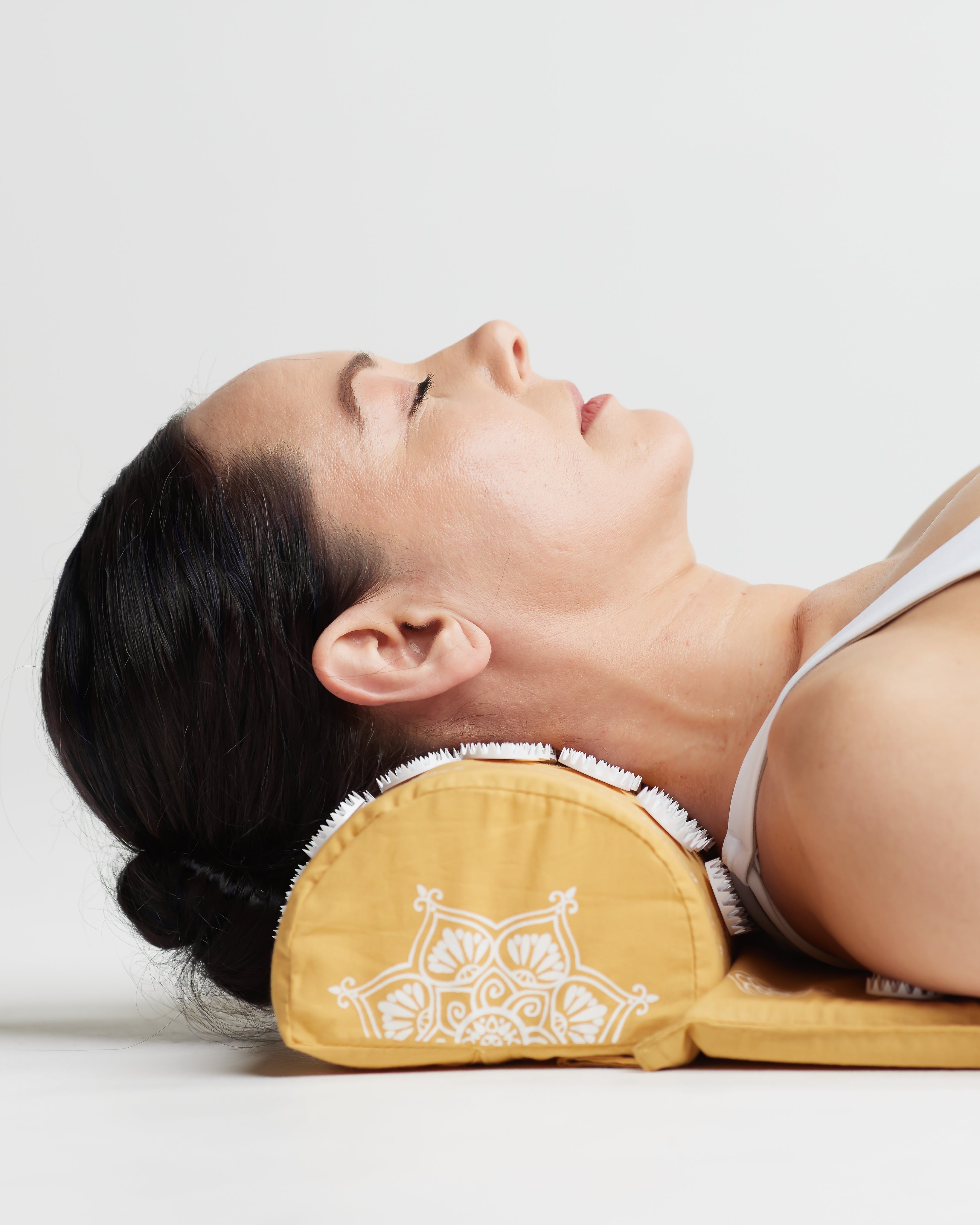 shakti-acupressure-pillow-yellow-level-2-model-side.jpg